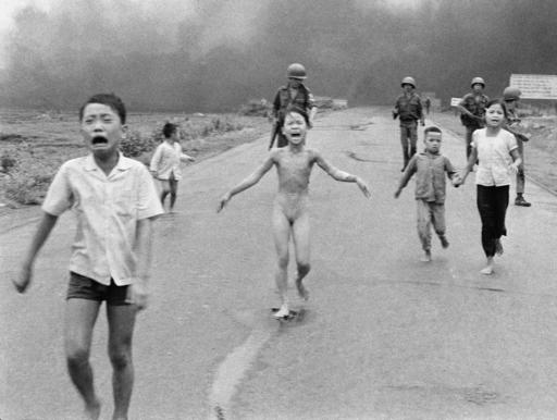 South Vietnamese forces follow terrified children, including 9-year-old Kim Phuc, center, as they run down Route 1 near Trang Bang after an aerial napalm attack in Vietnam, June 8, 1972. (AP Photo/Nick Ut)