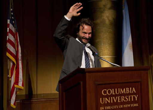 AP photographer Rodrigo Abd waves during the award ceremony of the Maria Moors Cabot Prize at Columbia University in New York City, Tuesday, Oct. 18, 2016. (AP Photo/Enric Marti)