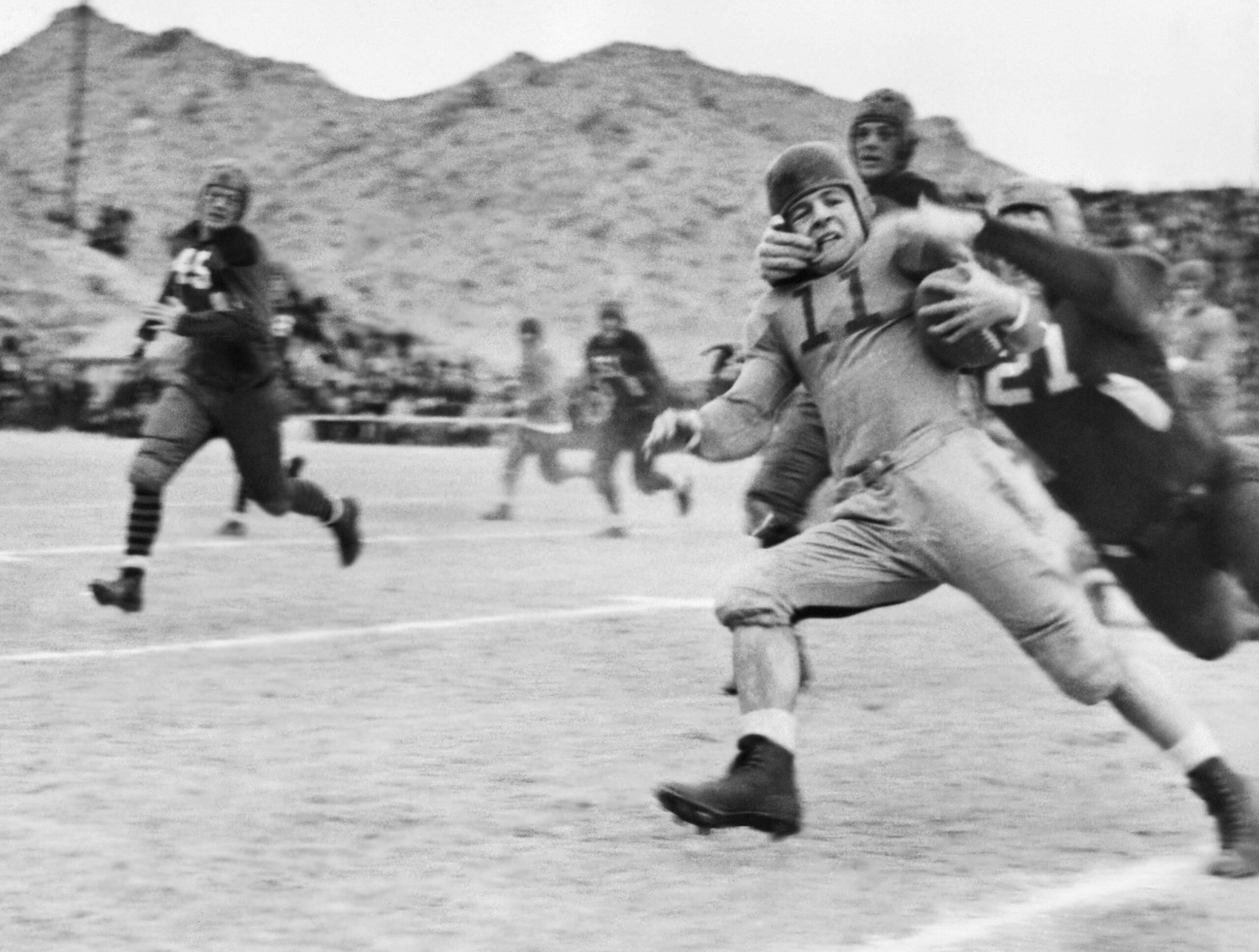 This photo, from the close of the first season of the AP poll, shows Texas Tech's famed Elmer Tarbox, No. 21, at extreme right, giving the well-known neck tie tackle at the Sun Bowl in El Paso, Texas, on Jan. 2, 1937. (AP Photo) 