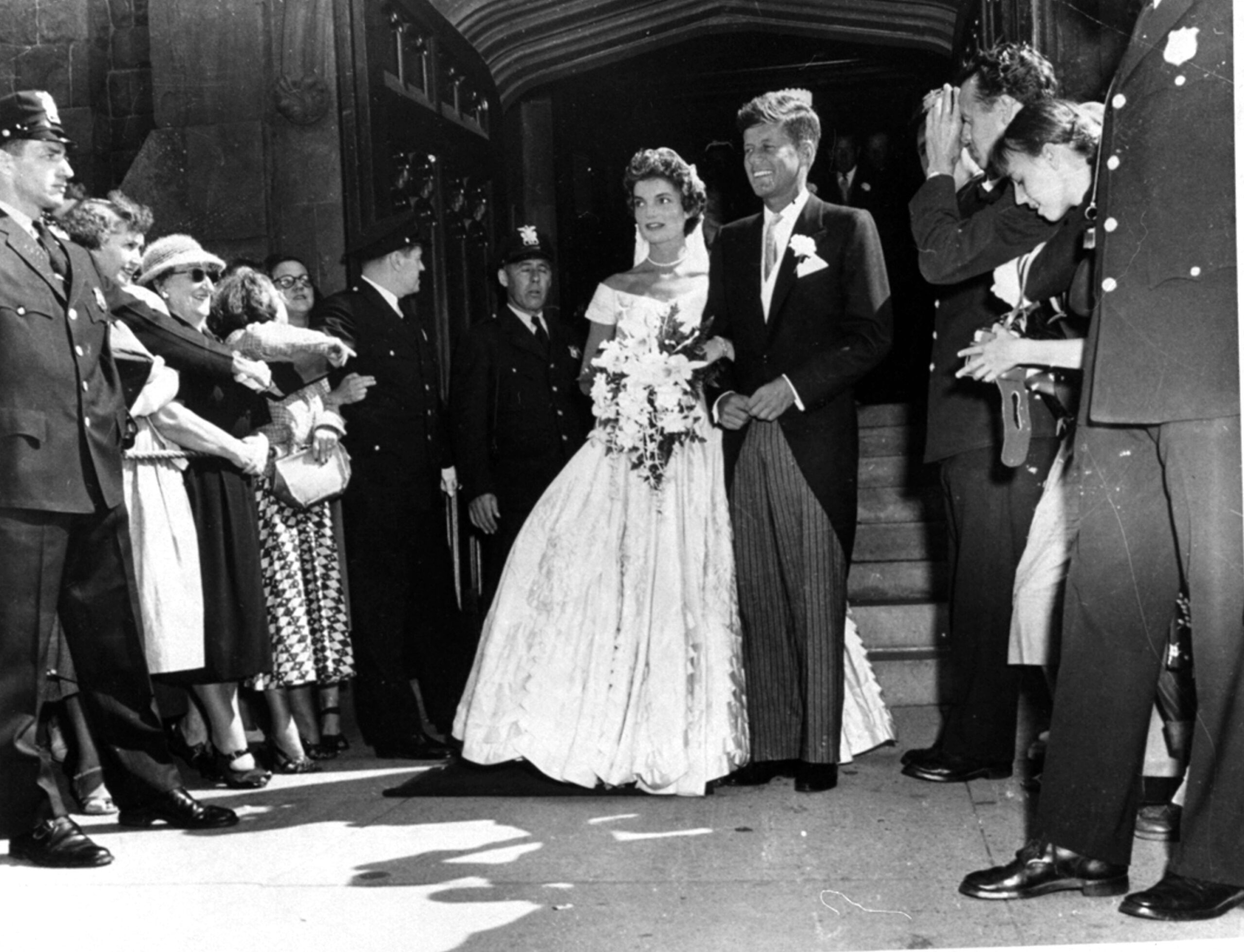 Archival and breaking-news images from AP are part of its new distribution agreement with Shutterstock Editorial. Above, Sen. John F. Kennedy, D-Mass., is shown with his bride, the former Jacqueline Bouvier, leaving a Newport, Rhode Island church after their wedding on Sept. 12, 1953. (AP Photo) Below, New England Patriots quarterback Tom Brady, left, and Denver Broncos quarterback Peyton Manning speak following the AFC championship game Sunday, Jan. 24, 2016, in Denver. (AP Photo/David Zalubowski)