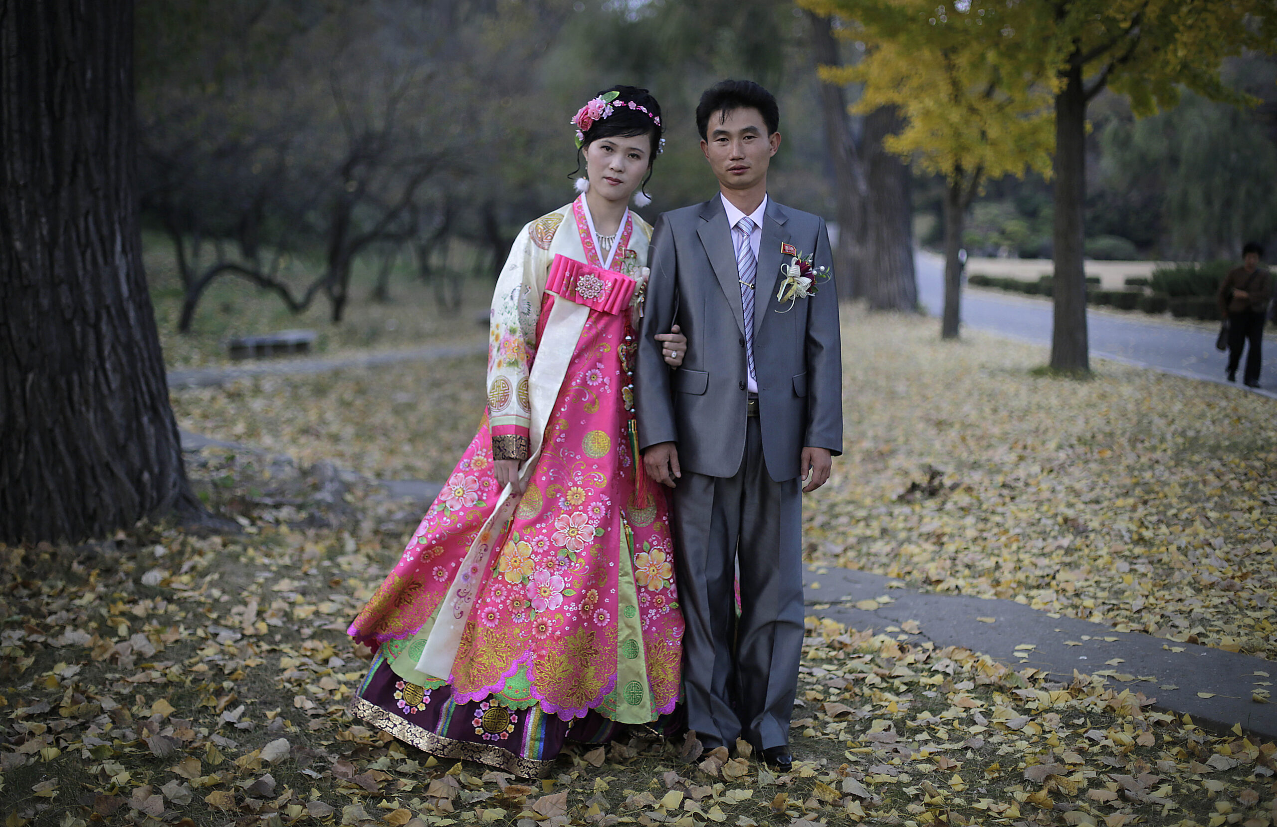 In this photo taken Saturday, Oct. 25, 2014, a North Korean bride and groom pose for a photograph at the Moranbong hill where they went to take wedding pictures, in Pyongyang, North Korea. The couple, Ri Ok Ran, 28 and Kang Sung Jin, 32, were married Saturday after dating for about two years. This is one of over 70 photos that will be on display at Objectifs in Singapore. (AP Photo/Wong Maye-E) 