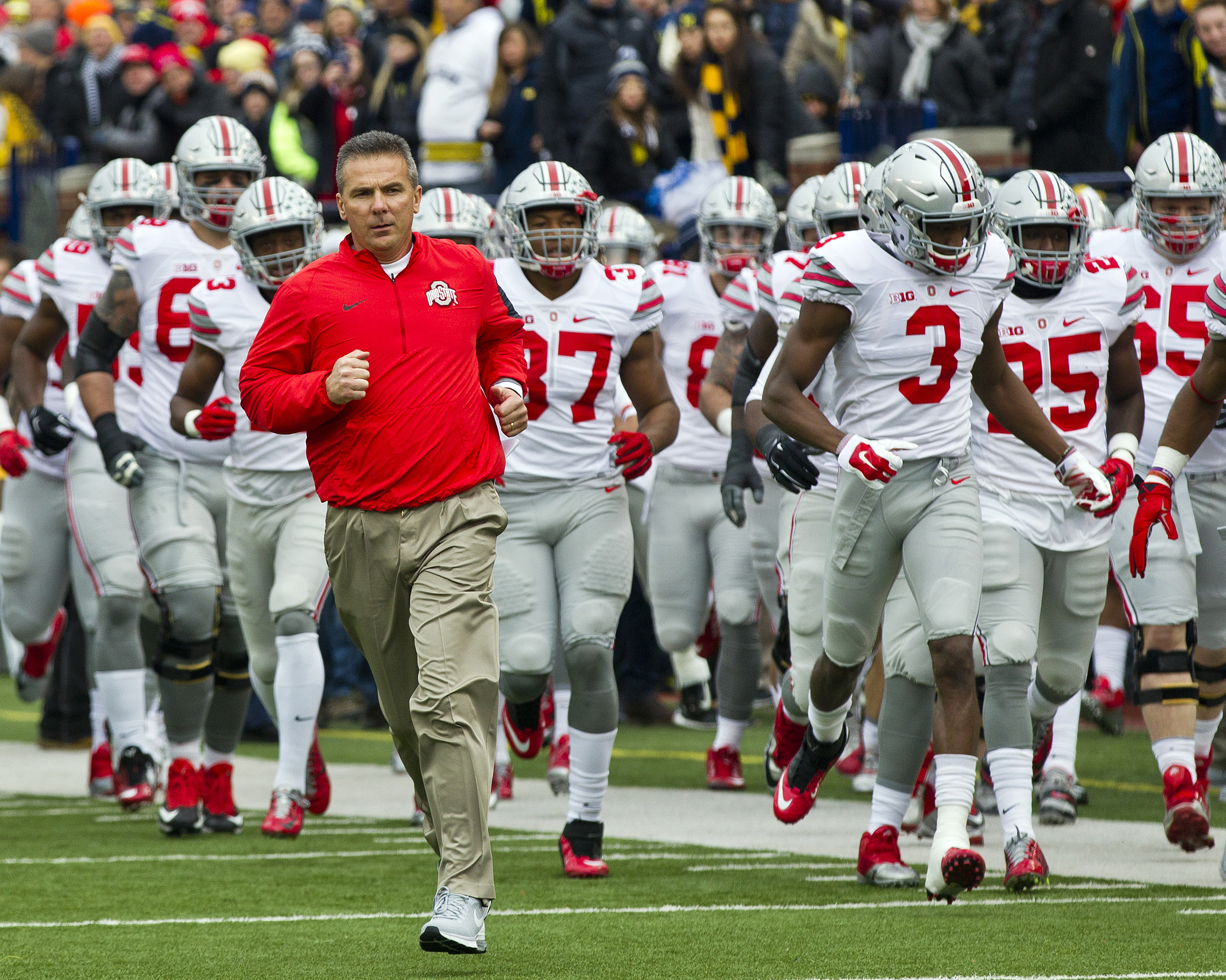 Last year's top-ranked team in the AP Top 25 preseason poll was Ohio State University, whose head coach, Urban Meyer, is seen here leading his team onto the field before playing the University of Michigan in Ann Arbor, Michigan, Nov. 28, 2015. (AP Photo/Tony Ding)