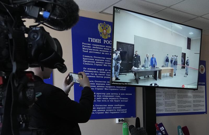 Journalists film a TV screen translating a court session of Russian opposition leader Alexei Navalny, in Pokrov, Vladimir region, east of Moscow, Russia, March 22, 2022. (AP Photo)