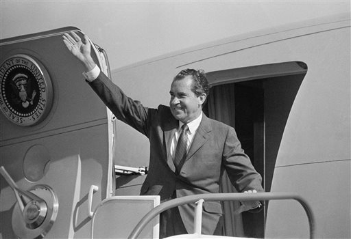 In this March 10, 1969, file photo taken by Toby Massey, President Richard M. Nixon waves from the doorway of Air Force One in Homestead, Fla. Massey, a photographer and photo editor who directed coverage of many prominent events during his 38-year career with The Associated Press, died Thursday, Aug. 21, 2014. He was 80. (AP Photo/Toby Massey)