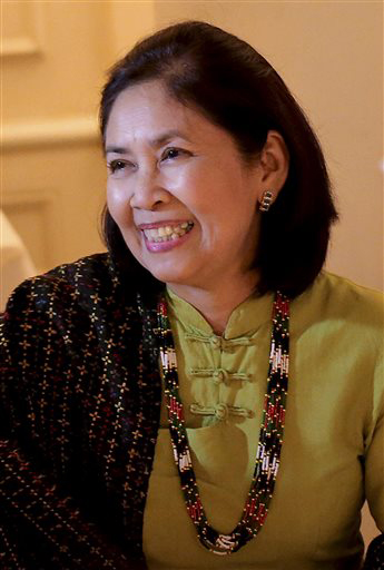 In this August 6, 2013, photo, Aye Aye Win, center, The Associated Press chief of bureau for Myanmar, is seated during a dinner in Yangon, Myanmar. After 25 years with AP, Aye Aye Win, 61, is retiring after a career that followed the legacy left by her father, U Sein Win, AP’s Myanmar correspondent from 1969-1989, who was jailed three times while fighting for press freedom. (AP Photo/Wong Maye-E)