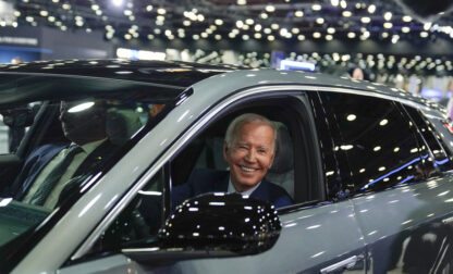 FILE - President Joe Biden drives a Cadillac Lyriq through the show room during a tour at the Detroit Auto Show, Sept. 14, 2022, in Detroit. (AP Photo/Evan Vucci, File)