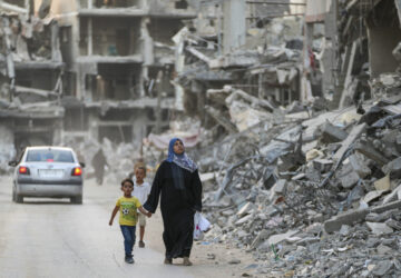 Palestinians walk through the destruction left by the Israeli air and ground offensive on Khan Younis, Gaza Strip, Thursday, Sept. 12, 2024. (AP Photo/Abdel Kareem Hana)