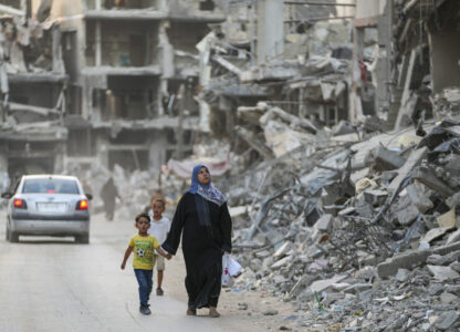 Palestinians walk through the destruction left by the Israeli air and ground offensive on Khan Younis, Gaza Strip, Thursday, Sept. 12, 2024. (AP Photo/Abdel Kareem Hana)