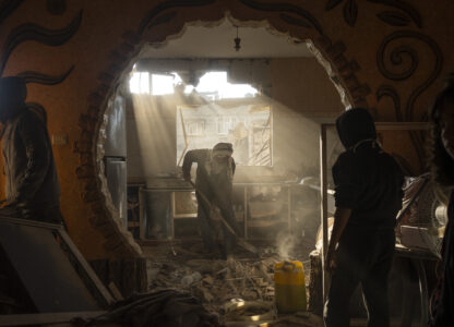 FILE - Palestinians look at their neighbor's damaged house following an Israeli strike in Rafah, southern Gaza Strip, Saturday, Jan. 27, 2024. (AP Photo/Fatima Shbair, File)