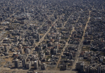 FILE - Destroyed buildings are seen through the window of an airplane from the U.S. Air Force overflying the Gaza Strip, Thursday, March 14, 2024. (AP Photo/Leo Correa, File)