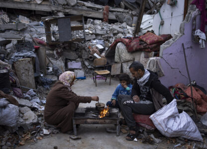 FILE - Members of the Al-Rabaya family break their fast during the Muslim holy month of Ramadan outside their home destroyed by Israeli airstrikes in Rafah, Gaza Strip, Monday, March 18, 2024. (AP Photo/Fatima Shbair, File)