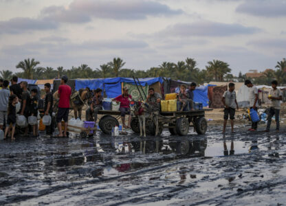 FILE - Palestinians gather to fill water jugs near one of the strip's few functioning desalination plants in Deir al-Balah, Gaza Strip, Thursday, June 20, 2024. (AP Photo/Abdel Kareem Hana, File)