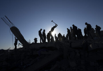 FILE - Palestinians search for bodies and survivors in the rubble of a house destroyed in an Israeli airstrike, in Rafah, southern Gaza Strip, Sunday, Jan. 7, 2024. (AP Photo/Fatima Shbair, File)