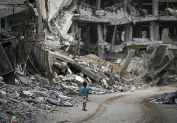 A child walks through the destruction left by the Israeli air and ground offensive on Khan Younis, Gaza Strip, Thursday, Sept. 12, 2024. (AP Photo/Abdel Kareem Hana)
