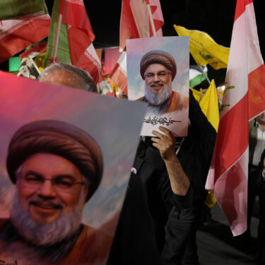 Iranian demonstrators hold posters of slain Hezbollah leader Hassan Nasrallah during an anti-Israeli protest at Felestin (Palestine) Square in Tehran, Iran, Tuesday, Oct. 1, 2024. (AP Photo/Vahid Salemi)