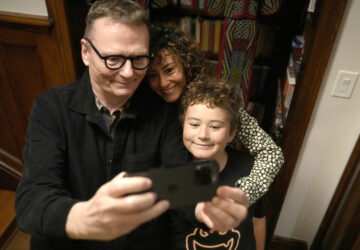 Nobel prize winner in Economics, James A. Robinson makes a selfie for the Nobel Foundation with his wife, Dr. Maria Angelica Bautista, and their son Adrian at their home in the Hyde Park neighborhood of Chicago, Monday, Oct. 14, 2024. (AP Photo/Charles Rex Arbogast)