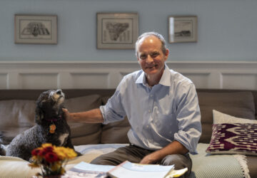 Economist Simon Johnson poses for a photograph with his dog Zoya after winning the Nobel memorial prize in economics with Daron Acemoglu and James A. Robinson, at his home in Washington, Monday, Oct. 14, 2024. (AP Photo/Ben Curtis)