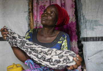 Nelly Shukuru, 51, hold the scarf she had planned on using to hang herself after spending three years displaced in the Lushagala camp in Goma, Democratic Republic of the Congo, Tuesday, Aug. 27, 2024. (AP Photo/Moses Sawasawa)