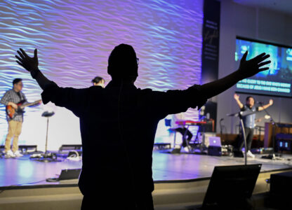 Pastor Owen Lee stretches his arms singing during a service at the Christ Central Presbyterian Church, Sunday, Oct. 13, 2024 in Centreville. (AP Photo/John McDonnell)