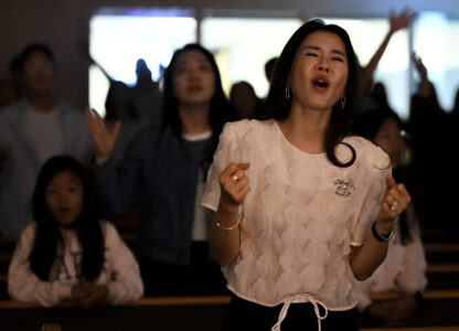 Joy Park prays during a service at the Christ Central Presbyterian Church, Sunday, Oct. 13, 2024 in Centreville. (AP Photo/John McDonnell)