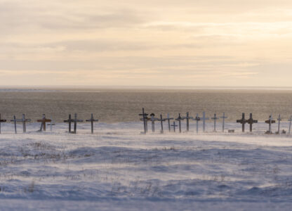 Wind blows snow along the surface of the village cemetery looking towards the Kaktovik Lagoon and the coastal plain of the Arctic National Wildlife Refuge, in Kaktovik, Alaska, Monday, Oct. 14, 2024. (AP Photo/Lindsey Wasson)