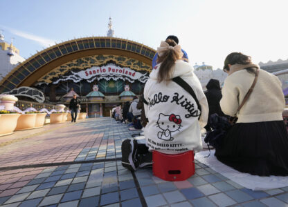 Hello Kitty fans wait in line before entering Sanrio Puroland to celebrate its best known character's 50th birth anniversary, in Tama, a western suburb of Tokyo, Japan, Friday, Nov. 1, 2024. (AP Photo/Hiro Komae)