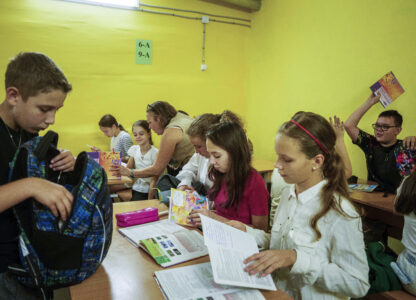 Children from Gymnasium No. 6 spread out their books in a school basement during an air alert in Zaporizhzhia, Ukraine, Sept. 3, 2024. (AP Photo/Evgeniy Maloletka)