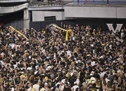 FILE - Vanderbilt fans carry a goalpost around the field after defeating Alabama in NCAA football game on Saturday, Oct. 5, 2024, in Nashville, Tenn. (AP Photo/John Amis, File)