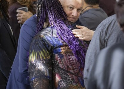 New Zealand's Prime Minister Christopher Luxon embraces a survivor following his 