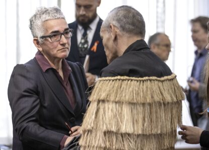 Solicitor-General Una Jagose, left, speaks with survivor Toni Jarvis following Prime Minister Christopher Luxon's 