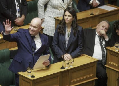 New Zealand's Prime Minister Christopher Luxon gestures to the public gallery as he makes a 