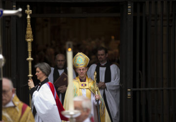 FILE - Britain's new Archbishop of Canterbury Justin Welby, center, leaves after his enthronement ceremony at Canterbury Cathedral in Canterbury, England, Thursday, March 21, 2013. (AP Photo/Matt Dunham, File)
