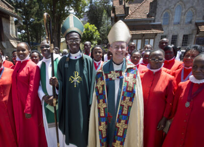 FILE - The Archbishop of Canterbury Justin Welby, center-right, accompanied by Archbishop of Kenya Eliud Wabukala, center-left, poses for a photograph with members of the choir after conducting a service at the All Saints Cathedral in Nairobi, Kenya, Sunday, Oct. 20, 2013. (AP Photo/Ben Curtis, File)