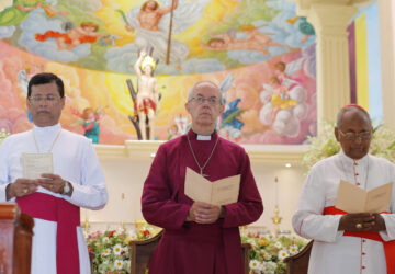 FILE - The Archbishop of Canterbury Justin Welby, center, pays homage to victims of the Easter Sunday attacks at St. Sebastian's church in Katuwapitiya village, Negombo , Sri Lanka, Thursday, Aug. 29, 2019. (AP Photo/Eranga Jayawardena, File)