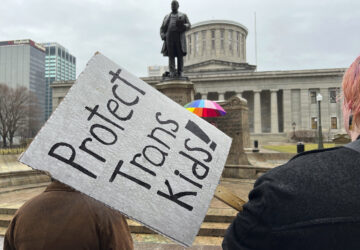 FILE - Protesters advocating for transgender rights and healthcare stand outside of the Ohio Statehouse, Jan. 24, 2024, in Columbus, Ohio. (AP Photo/Patrick Orsagost, File)