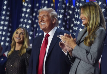 Republican presidential nominee former President Donald Trump stands on stage with former first lady Melania Trump, as Lara Trump watches, at an election night watch party at the Palm Beach Convention Center, Wednesday, Nov. 6, 2024, in West Palm Beach, Fla. (AP Photo/Evan Vucci)