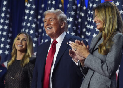 Republican presidential nominee former President Donald Trump stands on stage with former first lady Melania Trump, as Lara Trump watches, at an election night watch party at the Palm Beach Convention Center, Wednesday, Nov. 6, 2024, in West Palm Beach, Fla. (AP Photo/Evan Vucci)