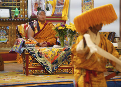 U.S.-born Buddhist lama, Jalue Dorje, watches a traditional Tibetan performance at his 18th birthday and enthronement ceremony in Isanti, Minn., on Saturday, Nov. 9, 2024. (AP Photo/Jessie Wardarski)
