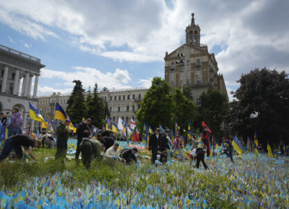 Volunteers put in order the site of an improvised memorial to fallen soldiers on Independence Square in Kyiv, Ukraine, Wednesday, May 15, 2024. (AP Photo/Efrem Lukatsky)