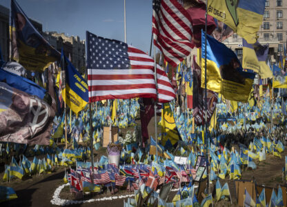 US and Ukrainian national flags wave to commemorate American volunteers, who were killed in battles with Russian troops defending Ukraine, their names are on flags, at the improvised war memorial in Independence square in Kyiv, Ukraine, Friday, Sept. 27, 2024. (AP Photo/Efrem Lukatsky)