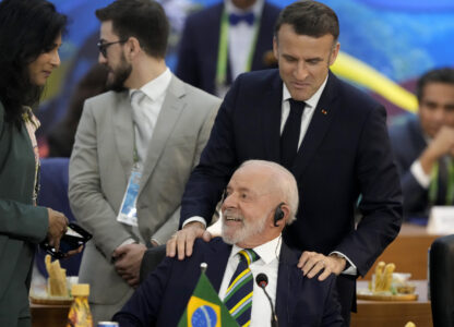 France's President Emmanuel Macron, top, and Brazil's President Luiz Inacio Lula da Silva talk during the G20 Summit leaders meeting in Rio de Janeiro, Monday, Nov. 18, 2024. (AP Photo/Eraldo Peres)