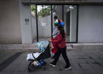 Residents pass by the shuttered Text&Image bookstore in Shanghai, Oct. 9, 2024. (AP Photo/Andy Wong)