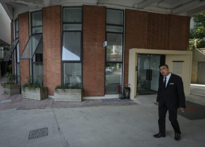 A man stands near what is formerly a branch of the Jiazazhi bookstore in Shanghai, Oct. 10, 2024. (AP Photo/Andy Wong)