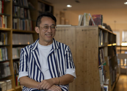 Yu Miao, owner of JF Books, smiles as he speaks to The Associated Press in his bookstore in Washington, Thursday, Oct. 3, 2024. (AP Photo/Ben Curtis)