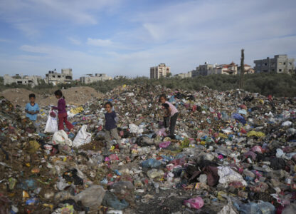 Palestinian kids sort through trash at a landfill in Zawaida, Gaza Strip, Sunday, Nov. 17, 2024. (AP Photo/Abdel Kareem Hana)