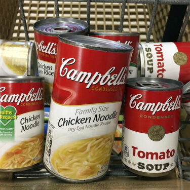 FILE - This May 23, 2017, file photo shows a variety of Campbell's soups in a grocery cart at a store in Phoenix. (AP Photo/Ross D. Franklin, File)