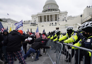 FILE - Violent insurrections loyal to President Donald Trump try to break through a police barrier at the Capitol in Washington on Jan. 6, 2021. (AP Photo/Julio Cortez, File)