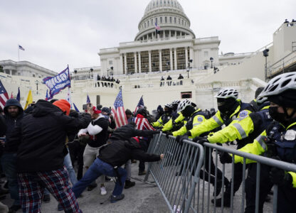 FILE - Violent insurrections loyal to President Donald Trump try to break through a police barrier at the Capitol in Washington on Jan. 6, 2021. (AP Photo/Julio Cortez, File)