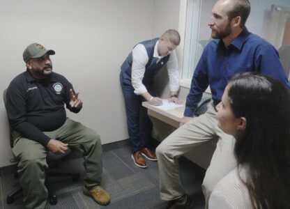 Federal Wildlife Officer Cody Smith and Border Patrol processing coordinator Yaira Santiago listen to Border Patrol agent Andry Fernandez during a training scenario where they practice their new chaplain skills, Wednesday, Nov. 20, 2024, in Dania Beach, Fla. (AP Photo/Marta Lavandier)