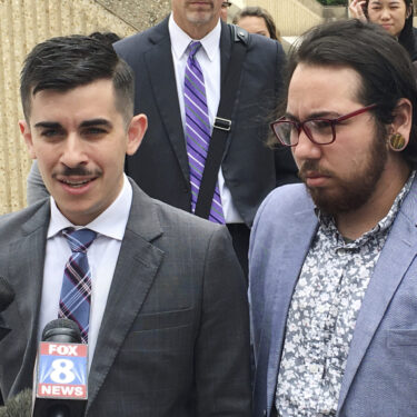 FILE - ACLU lawyer Chase Strangio, left, and plaintiff Joaquin Carcano address reporters after a hearing, June 25, 2018, in Winston-Salem, N.C., on their lawsuit challenging the law that replaced North Carolina's 